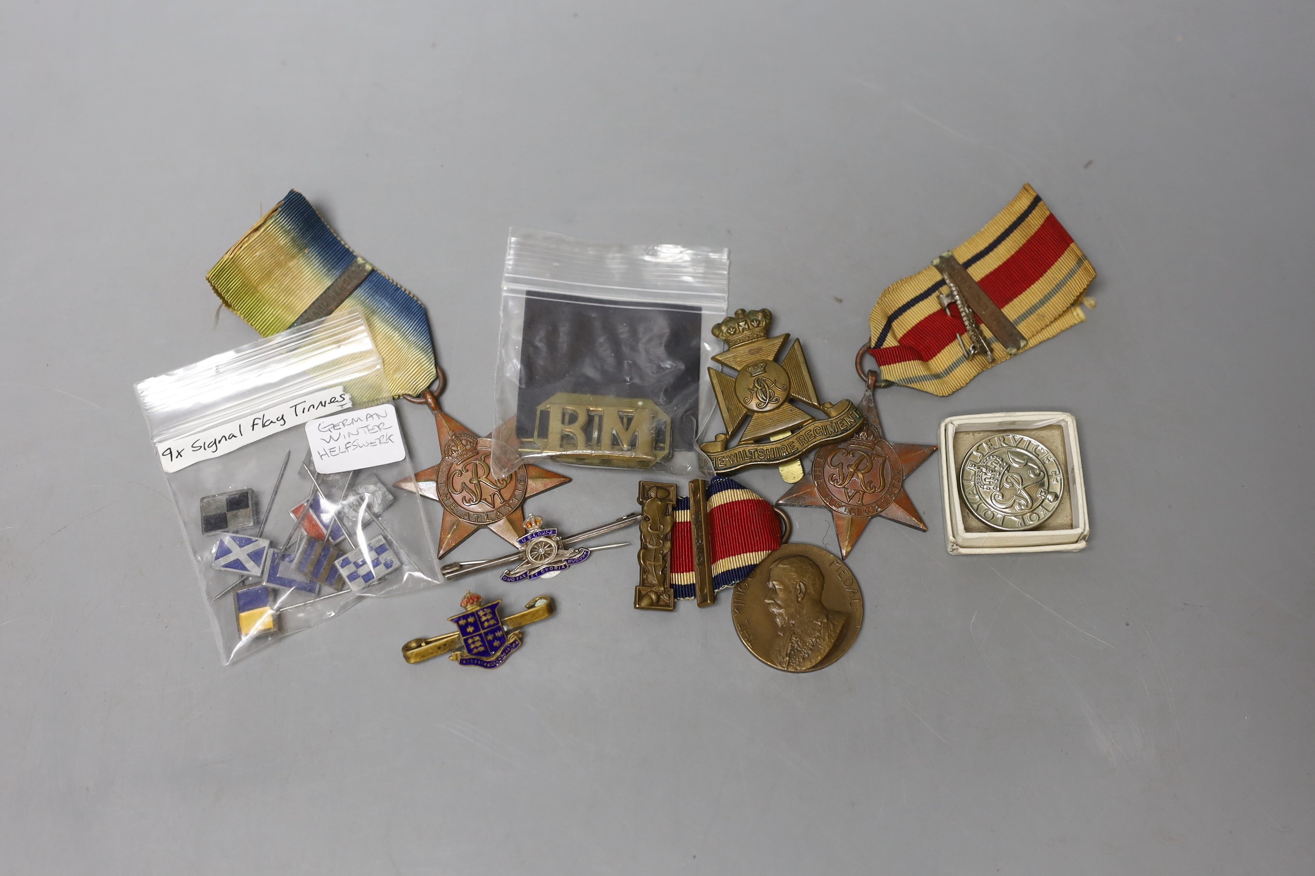 A WWII Atlantic Star, Africa Star, WWI The Kings Medal, German Signal Flag Tinnies, cap badges, etc.